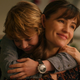 Adam hugs his mom from behind